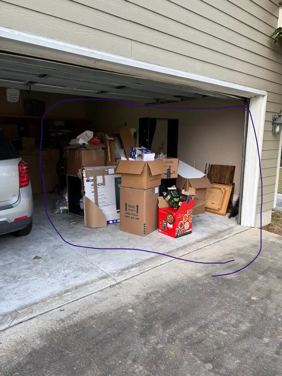 A Valdosta garage stacked with boxes and furniture before a Junk Doctor cleanout