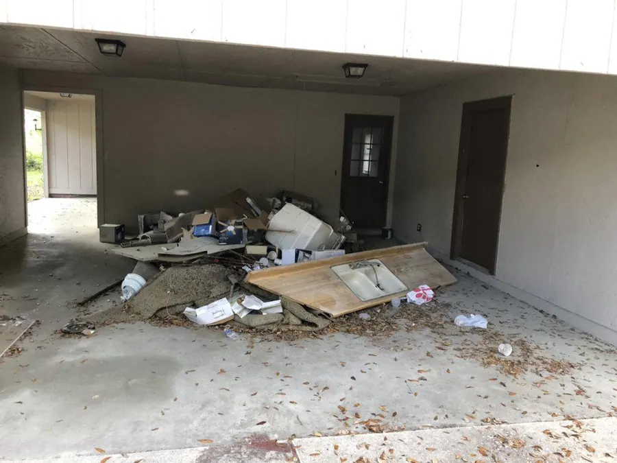 Post-renovation debris cleared from an empty interior carport